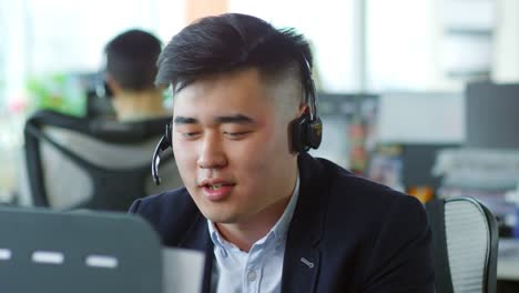 Asian-Man-Working-in-Customer-Service