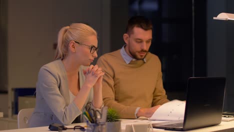 business-team-with-laptop-working-at-night-office