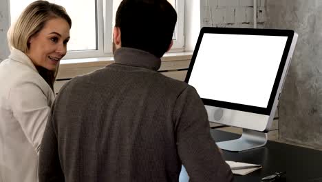 Two-young-businessman-having-a-meeting-at-office-looking-in-monitor.-White-Display