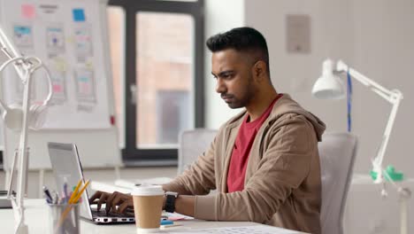 indian-creative-man-working-on-laptop-at-office