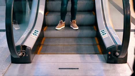 Anonymous-People-Walking-on-the-Escalator-Lift-in-Shopping-Mall