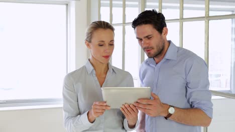 Content-colleagues-working-together-with-tablet