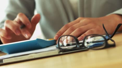 Closeup-woman-hands-on-calculator