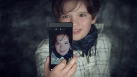 4K-Hi-Tech-Shot-of-a-Child-Doing-a-Selfie-on-his-Smartphone