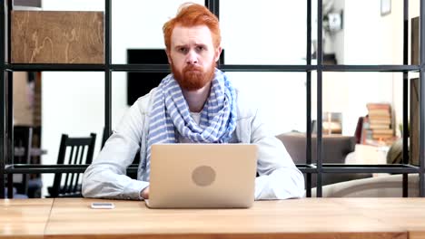 Thumbs-Down-by-Man-Working-on-Laptop