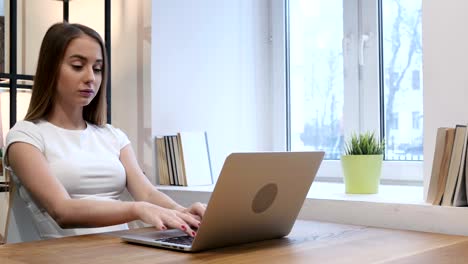 Thumbs-Down-by-Young-Girl-while-Working-on-Laptop