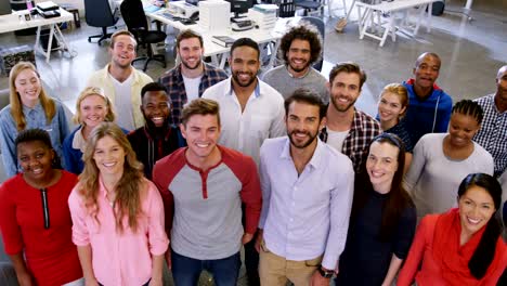 Portrait-of-business-team-standing-together-in-office