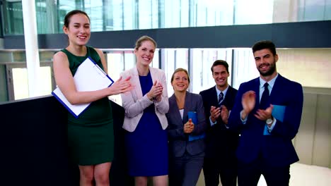 Business-executives-applauding-after-presentation