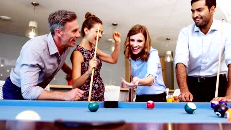 Executives-playing-pool-in-office