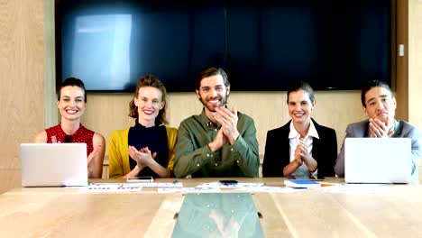 Business-team-applauding-during-meeting-in-conference-room