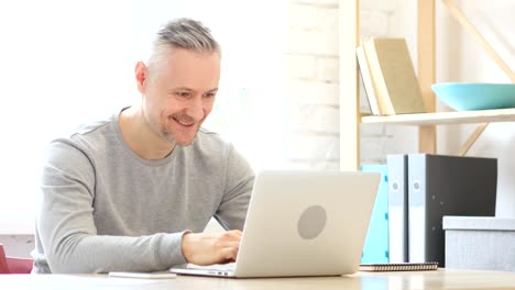 Excited-Middle-Aged-Man-Celebrating-Success-of-Work