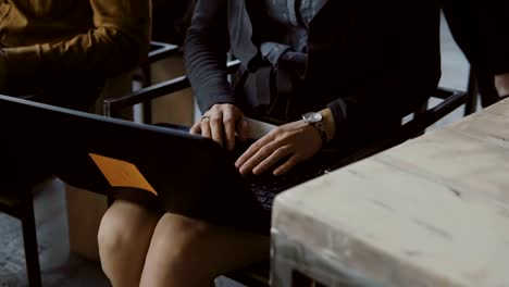 Close-up-view-of-young-businesswoman-typing-at-laptop.-Female-student-sitting-on-the-chair-at-seminar-at-lecture-hall