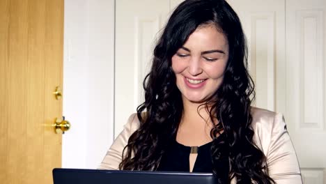 Plus-size-business-woman-working-on-laptop-computer-in-office