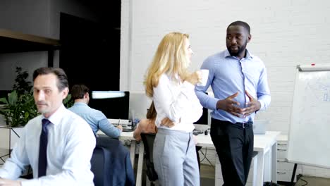 Business-Woman-Female-Boss-Listen-To-Coworker-Ideas-Walking-In-Modern-Office-Drinking-Coffee-While-Businesspeople-Group-Walking-On-Computers