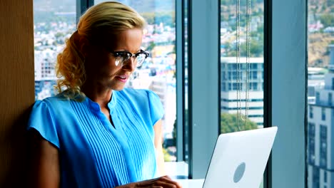 Female-executive-using-laptop