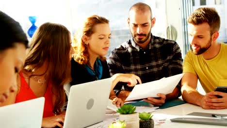 Team-of-executives-interacting-with-each-other-while-working-in-the-office