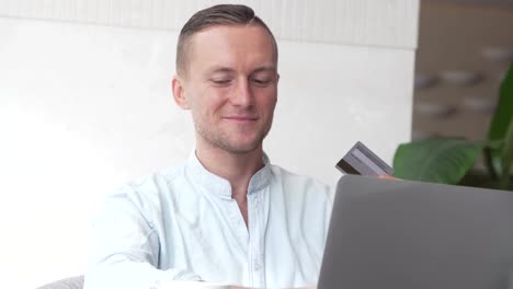 Handsome-businessman-buy-tickets-with-laptop-computer