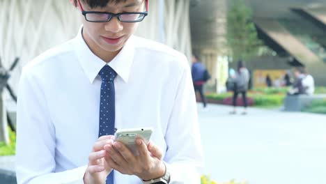 business-man-using-mobile-smart-phone-in-the-office