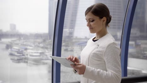 businesswoman-stay-opposite-window