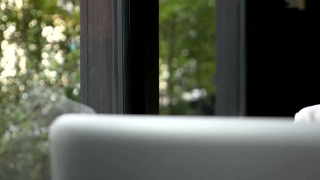 Asian-businesswoman-doing-work-by-typing-on-laptop-keyboard