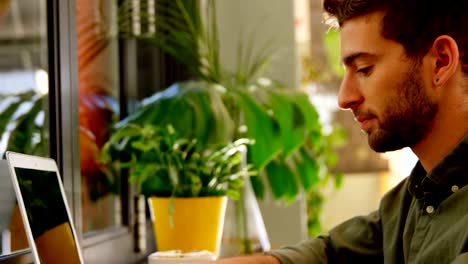 Close-up-of-handsome-man-using-laptop-at-table-4k