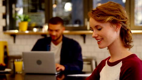 Smiling-woman-executive-working-in-the-office-cafeteria-4k