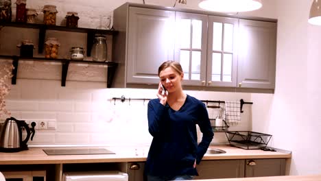 Woman-at-Night-Talking-on-Phone-in-Kitchen,-Answering-Call