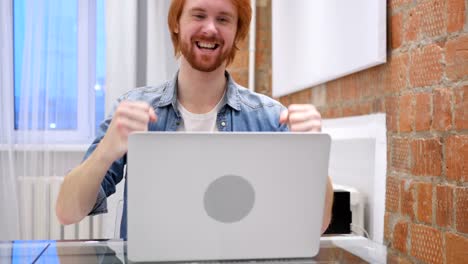 Excited-Redhead-Beard-Man-Celebrating-Success-of-work