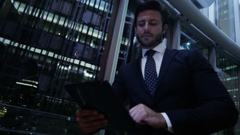 Arabic-businessman-using-wifi-tablet-downtown-office-night