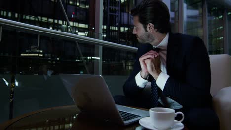 European-businessman-using-wifi-laptop-downtown-hotel-night