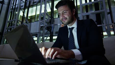 Caucasian-European-business-male-using-laptop-hotel-night