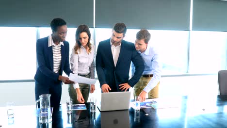 Business-colleagues-discussing-over-laptop-and-document-4k