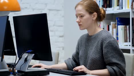 Redhead-Woman-Working-on-Computer-in-Office