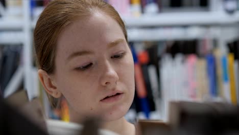 Close-Up-of-Woman-Searching-for-Book-in-Library