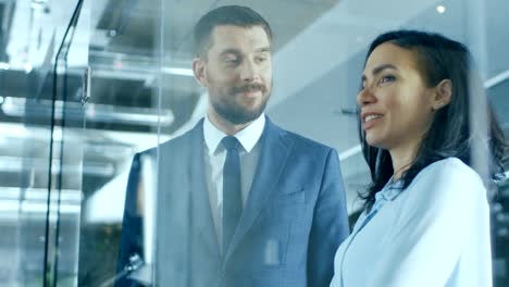 Businessman-and-Female-CEO-Talking-and-Chatting-while-Standing-in-the-Hallway.-Friendly-Conversation-of-Beautiful-People.