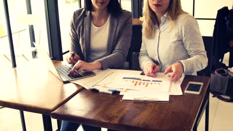 Two-young-beautiful-businesswoman-have-meeting-and-discussing-about-monthly-sale-report,-Business-and-finance-concept.