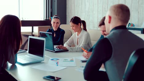 Woman-is-laughing-at-a-meeting-of-businessmen.-Colleagues-laugh-at-the-office