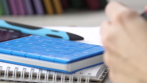 women's-hand-presses-on-the-keys-of-the-calculator