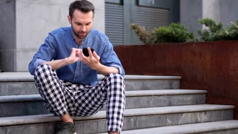 Casual-Man-Using-Smartphone-for-Browsing-online