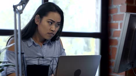 Pretty-ethnic-girl-working-at-computer-desk