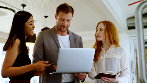 Business-colleagues-discussing-over-laptop-4k