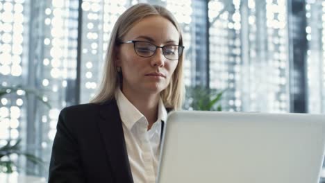 Young-Lady-Working-on-Laptop-in-Business-Center