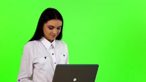 Beautiful-cheerful-businesswoman-working-on-her-laptop