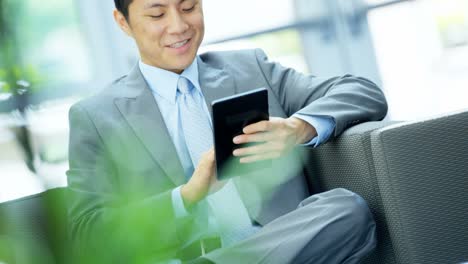 Portrait-Asian-Chinese-businessman-using-office-wireless-tablet