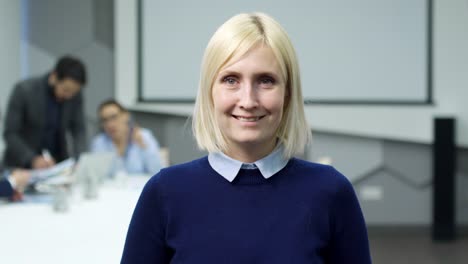 Joyous-Mid-Aged-Businesswoman-Posing-in-Office