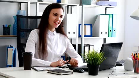 woman-speaking-on-headset-in-modern-office