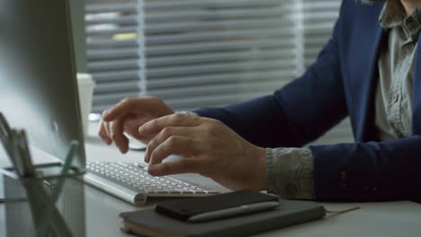 Unrecognizable-Man-Typing-on-Desktop-Computer