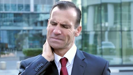 Tired-Middle-Aged-Businessman-with-Neck-Pain