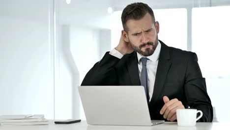 Tired-Businessman-with-Neck-Pain-at-Work