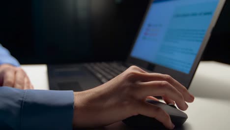 close-up-of-businesswoman-with-laptop-working-at-night-office